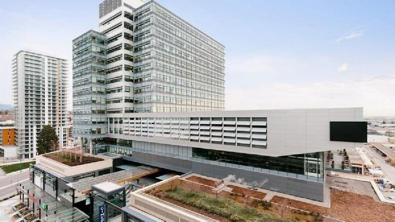 Exterior view of the glass-facade tower and retail podium at Marine Gateway, 450 Southwest Marine Drive.