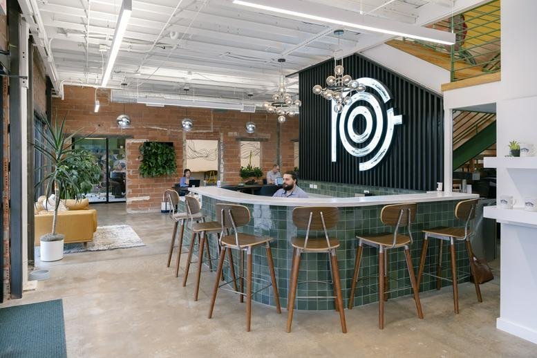Spacious reception area with a tiled curved bar and branded signage at Market Station.