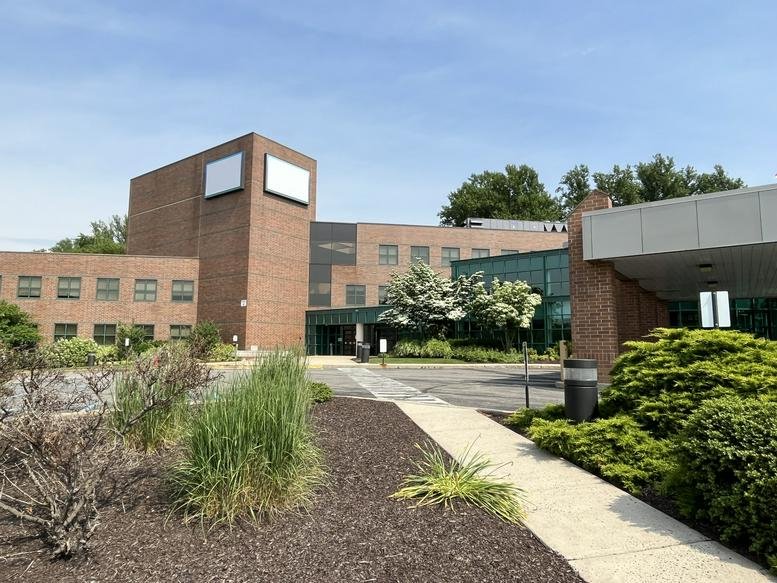 Exterior brick facade of Northbrook Corporate Center with a modern glass entrance.