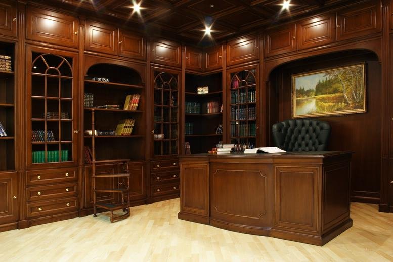 Wood-paneled private office at 1-38 Triangle Park Dr with a large executive desk and built-in bookshelves.