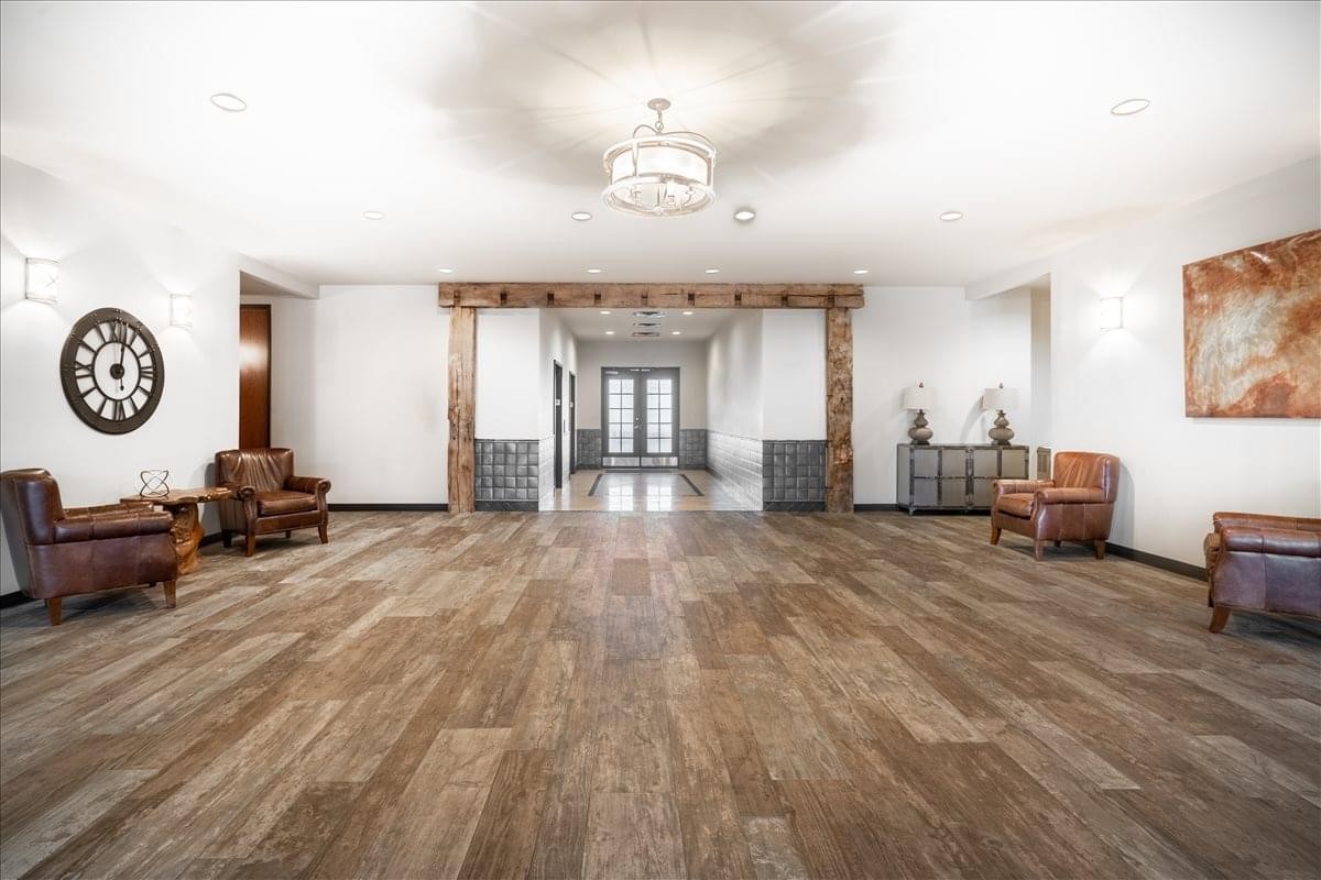 Spacious reception lobby at Old Town Square, Suite 450 with wood flooring and leather seating.
