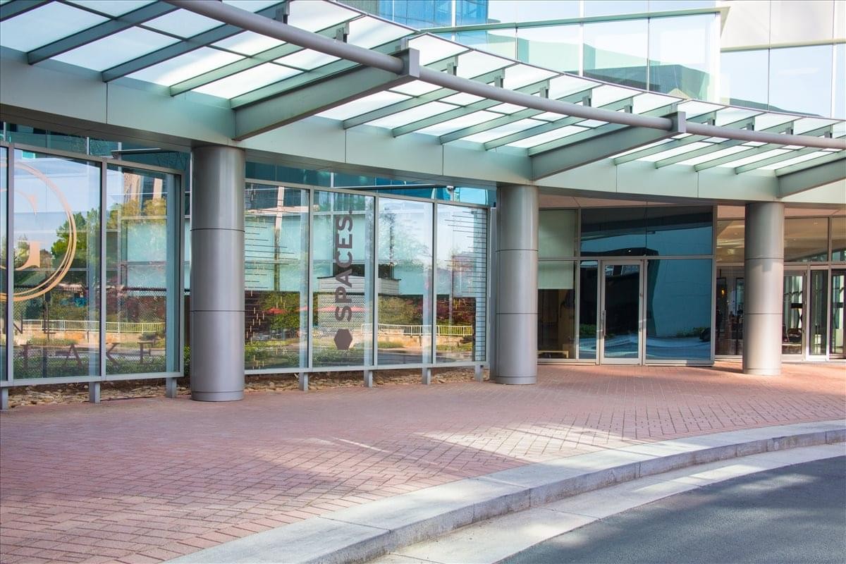 Exterior entrance under a glass canopy at One Glenlake Center.