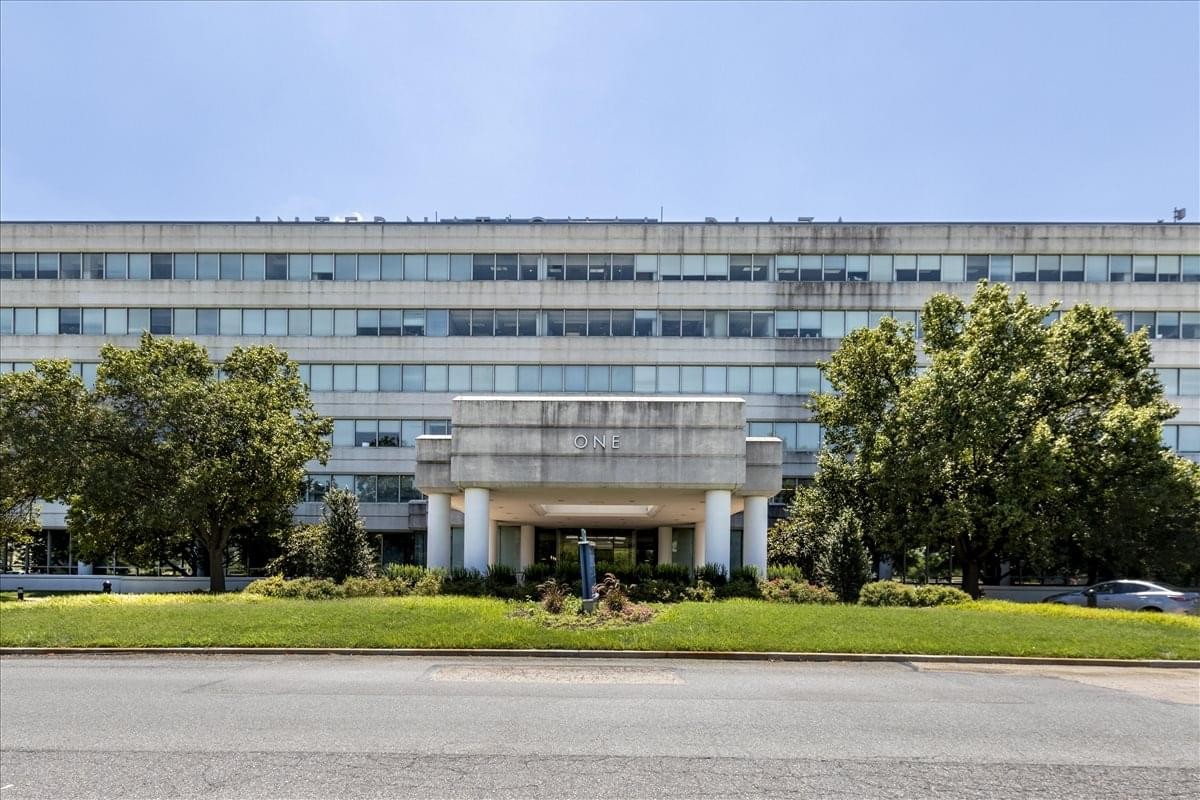 Exterior facade and landscaped entrance of the 1 International Plaza building.