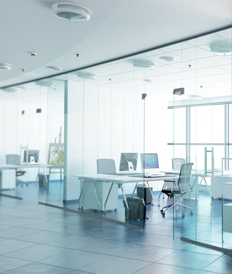 Bright, modern open-plan office at 1 Liberty Street, New York City featuring glass partitions and multiple workstations.