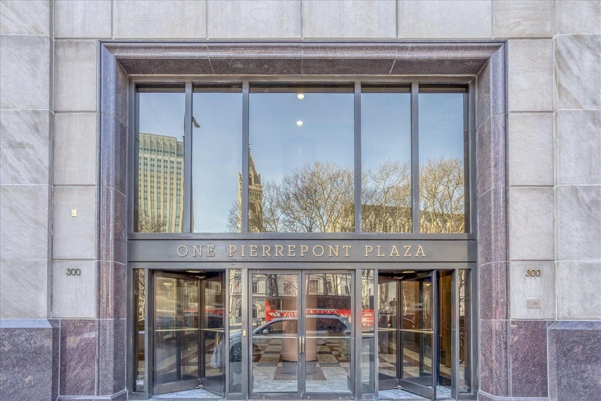 Building entrance with glass doors and stone facade at 1 Pierrepont Plaza.