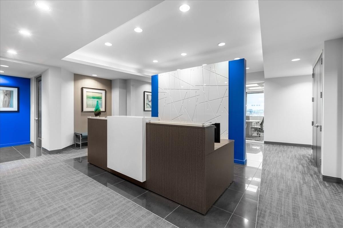 Professional reception desk at 10 Milner Business Court with modern white and blue accents.
