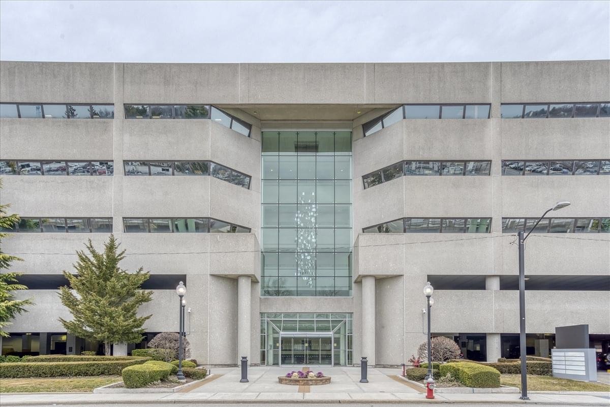 Exterior view of the concrete and glass facade of 100 Duffy Avenue.