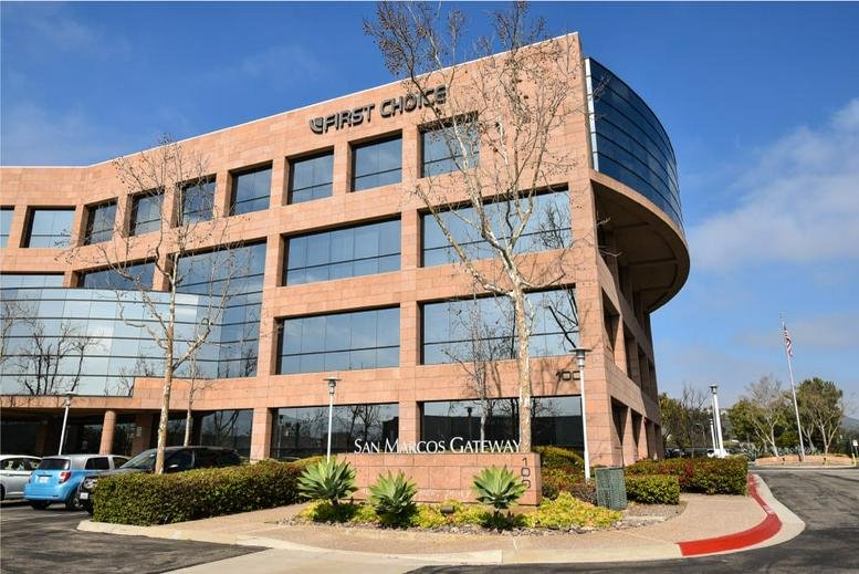 Exterior view of the brick San Marcos Offices building at 100 E. San Marcos Boulevard.