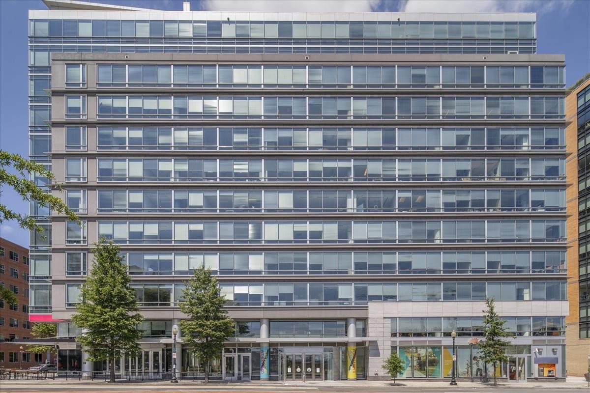 Modern multi-story glass and steel exterior of 100 M Street, S.E. in Washington DC.