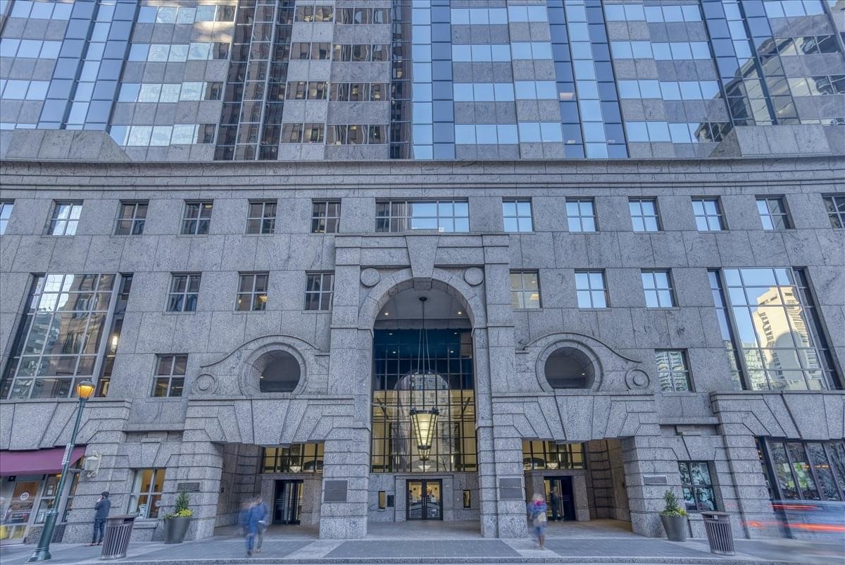 Grand stone facade and arched entrance of the 100 N 18th Street building.