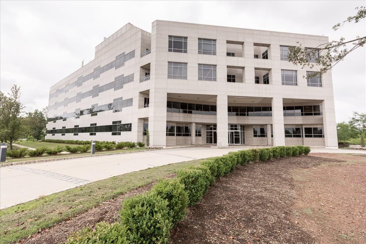 Exterior view of the multi-story stone facade at 100 Overlook Center.