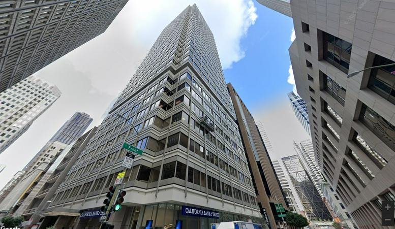 Exterior view of the high-rise building at 100 Pine St, Ste. 1250, San Francisco, California against a blue sky.