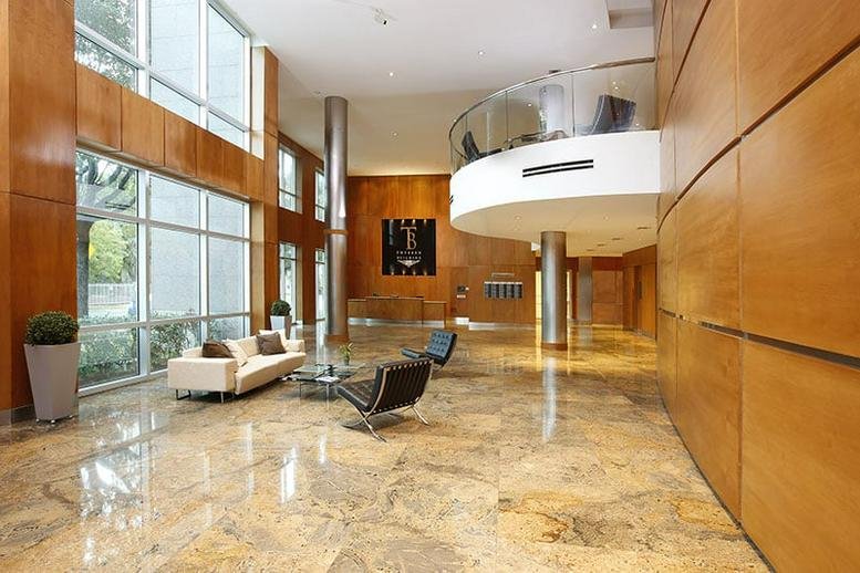 Grand lobby at 1000 5th Street, Suite 200 with marble floors and wood paneling.