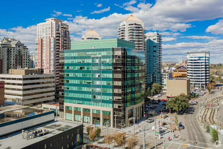 Exterior view of the glass and brick facade at Plaza 1000, 7 Avenue Southwest.