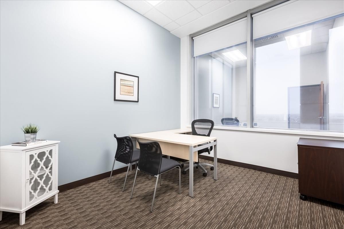 Bright private office at 1000 Lafayette Blvd. with two guest chairs and large window.