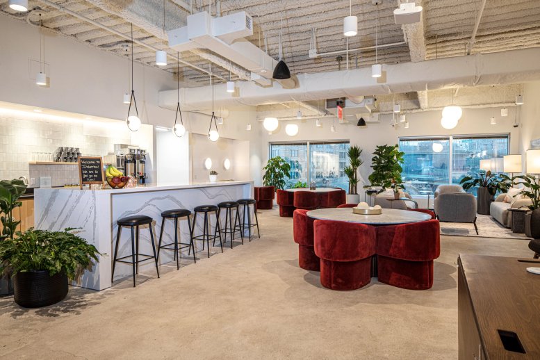 Spacious communal kitchen and bar area with marble counters and red velvet seating.