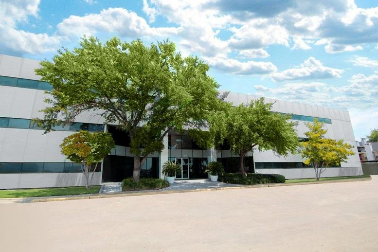 Exterior view of the white facade and landscaped entrance at 10039 Bissonnet Street.