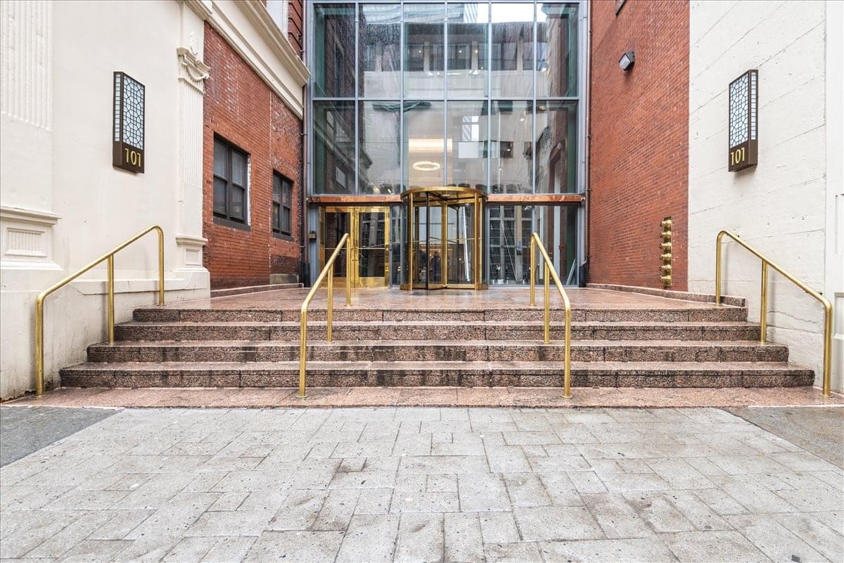 Exterior view of the glass entrance and revolving doors at 101 Arch Street.