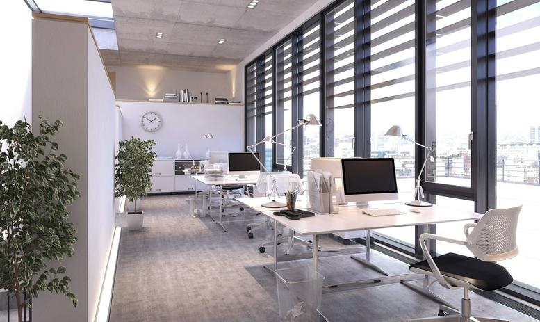 Modern open-plan workspace at 101 Parkshore Drive, Suite 100 with floor-to-ceiling windows and black desk chairs.