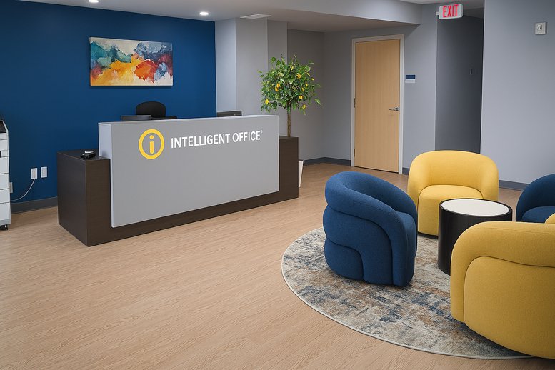 Modern reception area with a grey desk, blue feature wall, and yellow lounge chairs.