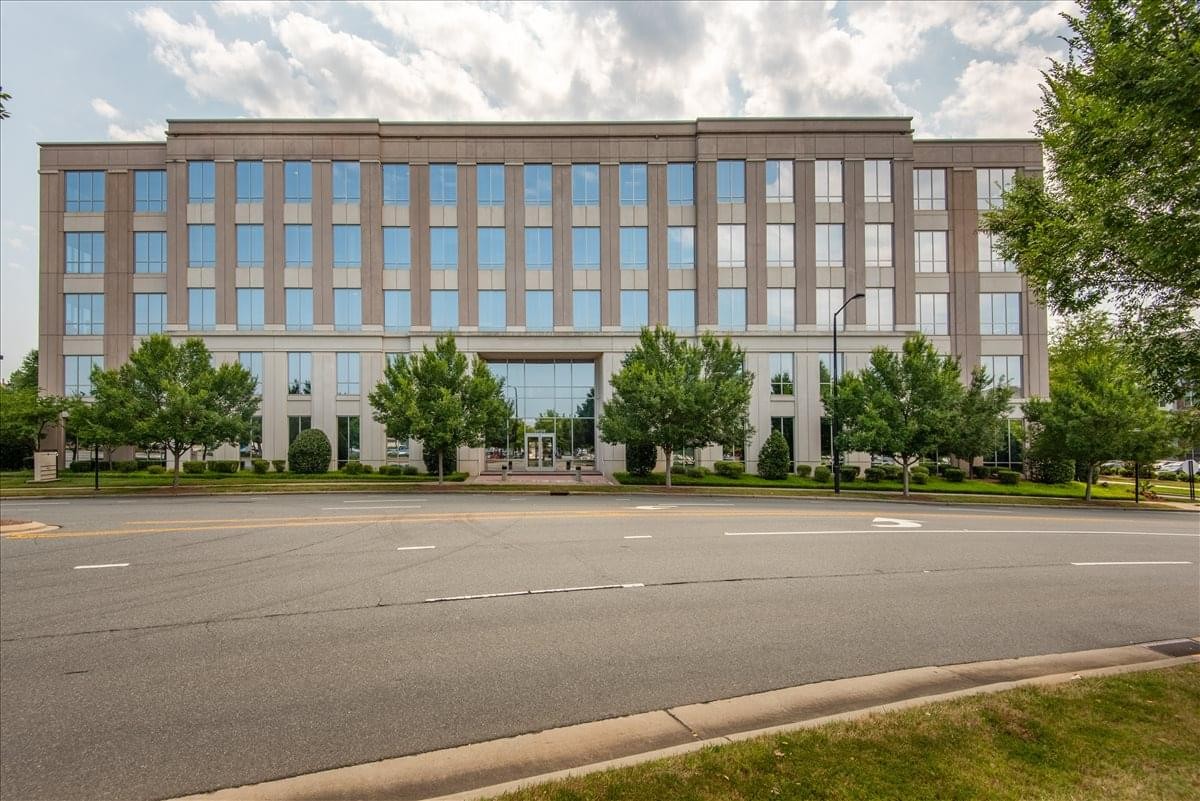Exterior view of the professional multi-story brick building at 10130 Perimeter Parkway.