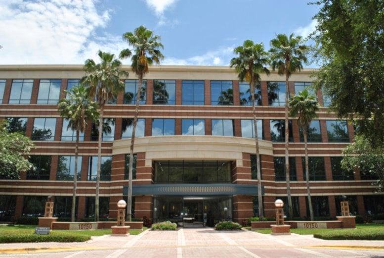 Exterior view of the brick facade and palm trees at Highland Oaks I.
