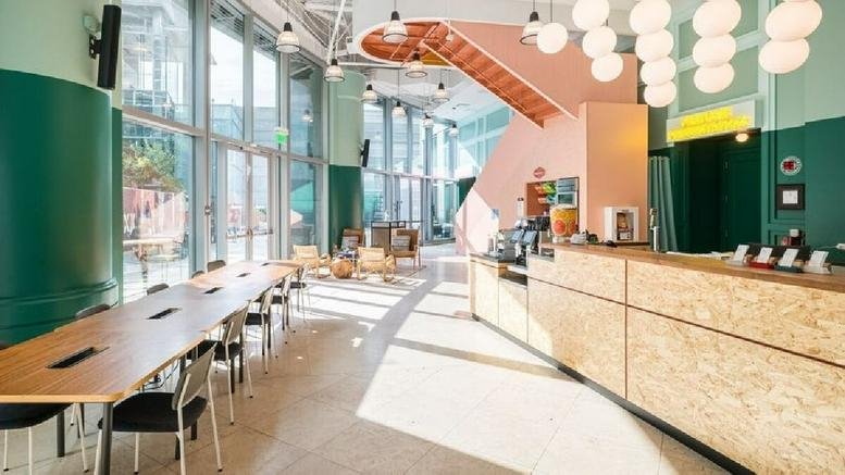 Spacious reception area and café with light wood counters at 10250 Constellation Blvd.