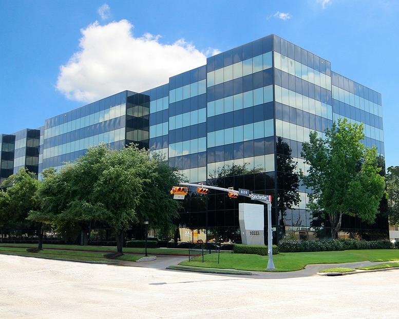 Exterior view of the multi-story glass and black facade building at 10333 Harwin Drive.