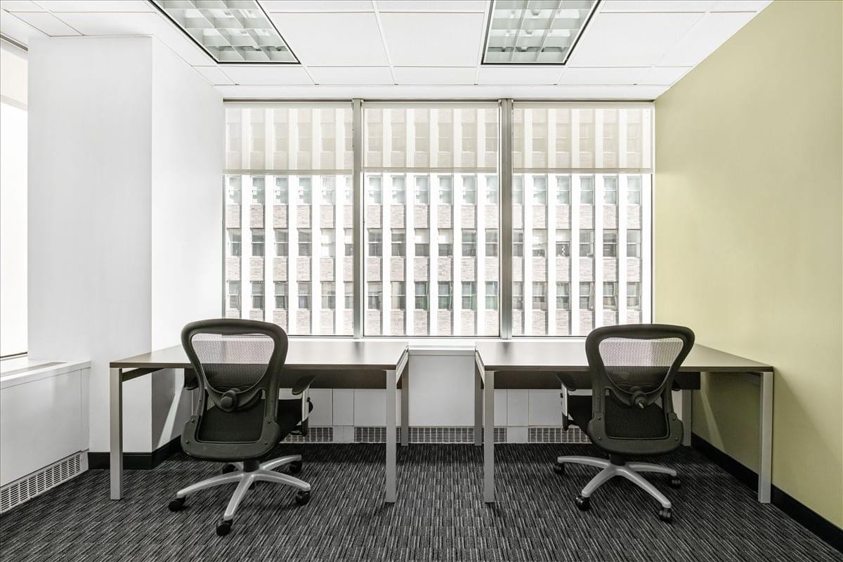 Three-person office suite at 104 West 40th Street, Suites 400 and 500 featuring black mesh chairs.