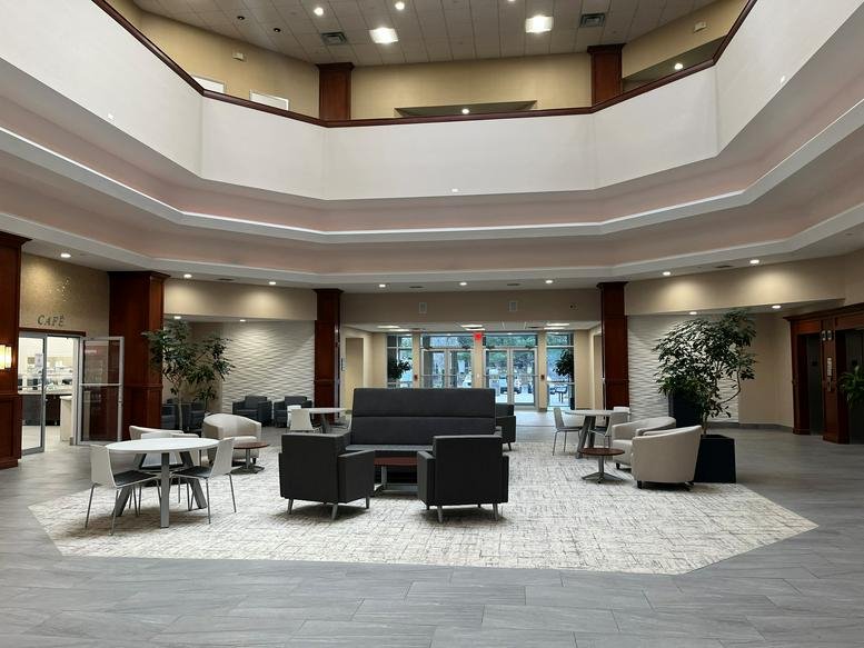 Spacious multi-level atrium lobby with modern seating areas at Melville Corporate Center I.