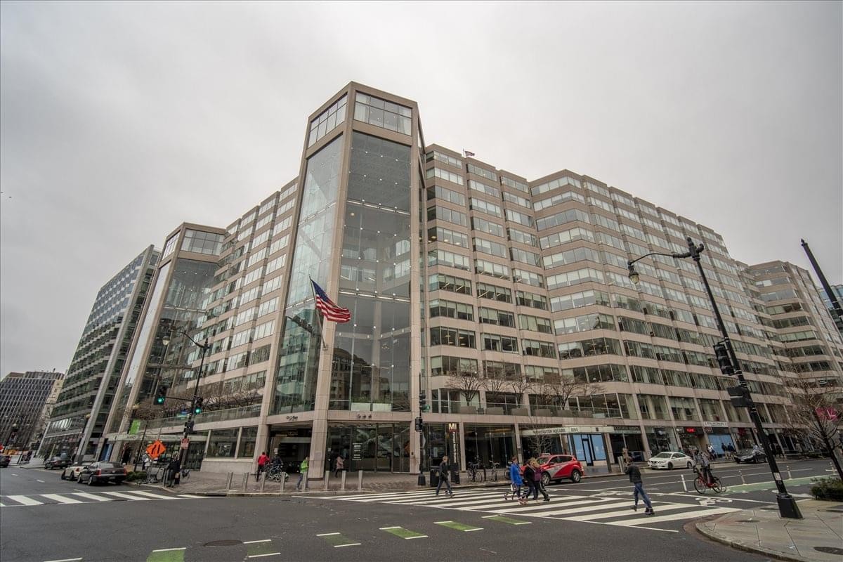 The grand exterior architecture and glass atrium of Washington Square at 1050 Connecticut Avenue NW.