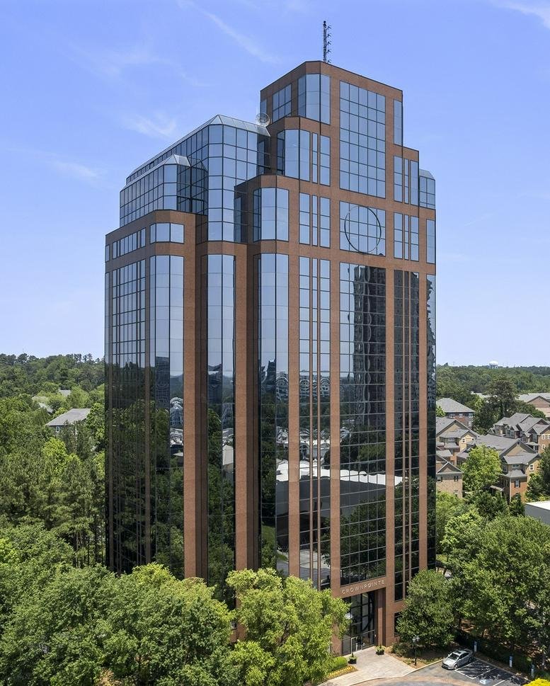 Exterior view of the glass and brick facade at 1050 Crown Pointe Parkway.