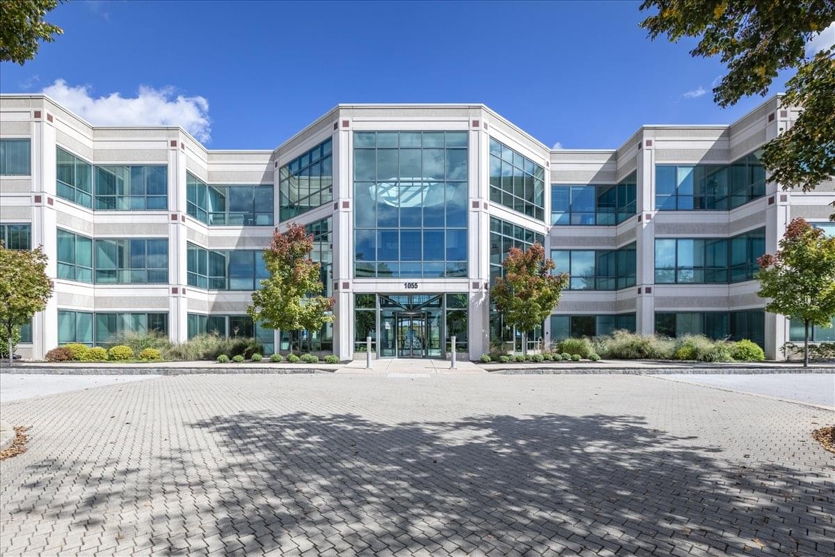 Exterior view of the multi-story glass-fronted building at 1055 Westlakes Drive.