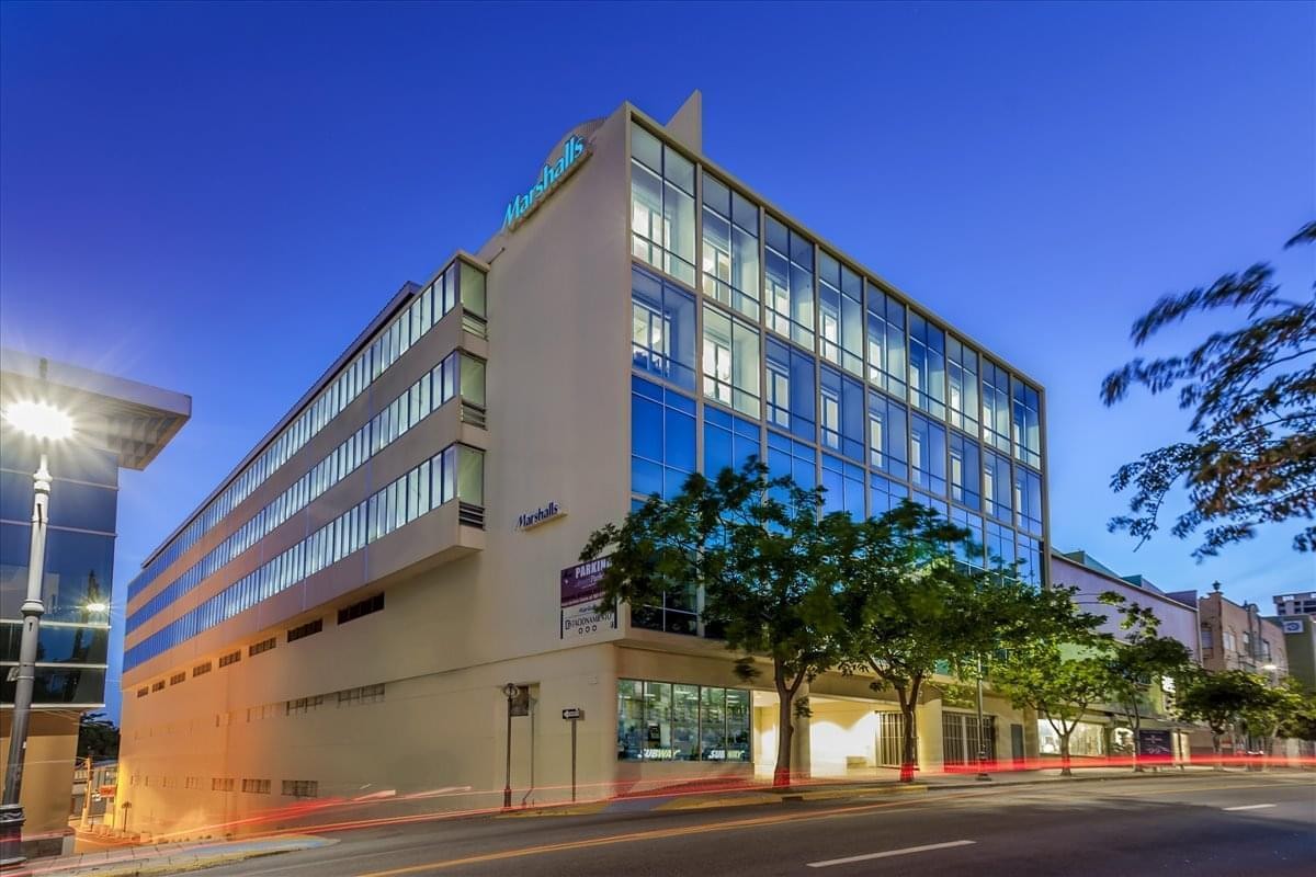 Modern multi-story exterior of the 1064 Ponce de Leon Avenue building at dusk.