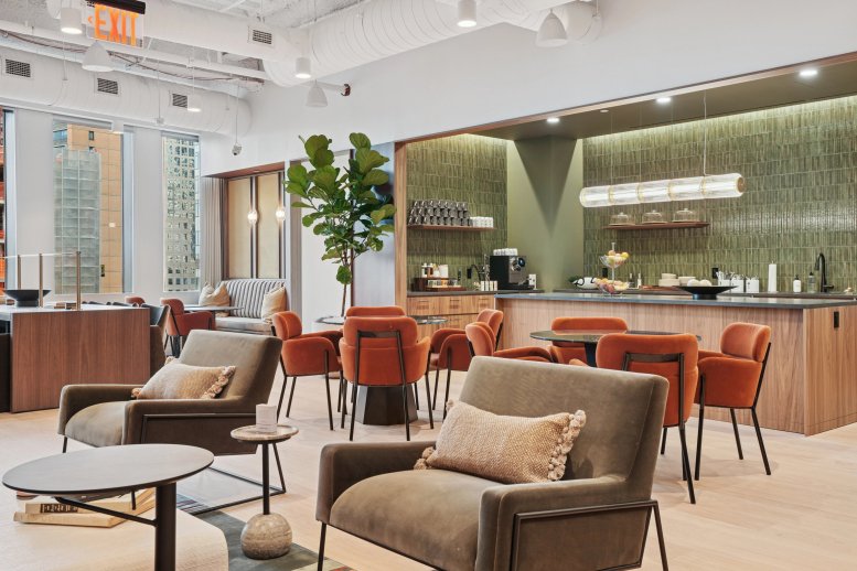 Spacious communal lounge at 107 Greenwich Street with plush armchairs and a modern kitchen area.