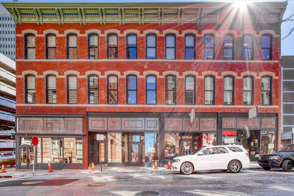 Exterior view of the historic red brick building at 107 W. 9th Street, 2nd Floor.
