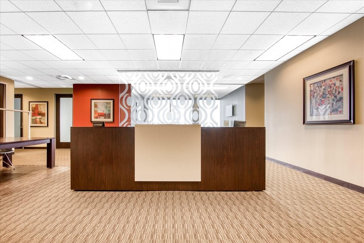 Modern reception desk at 11 N. Water Street, Suite 10290 with warm wood tones and bright lighting.