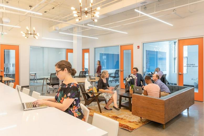 Spacious communal lounge at 11 S 12th Street featuring vibrant orange doors and modern seating.