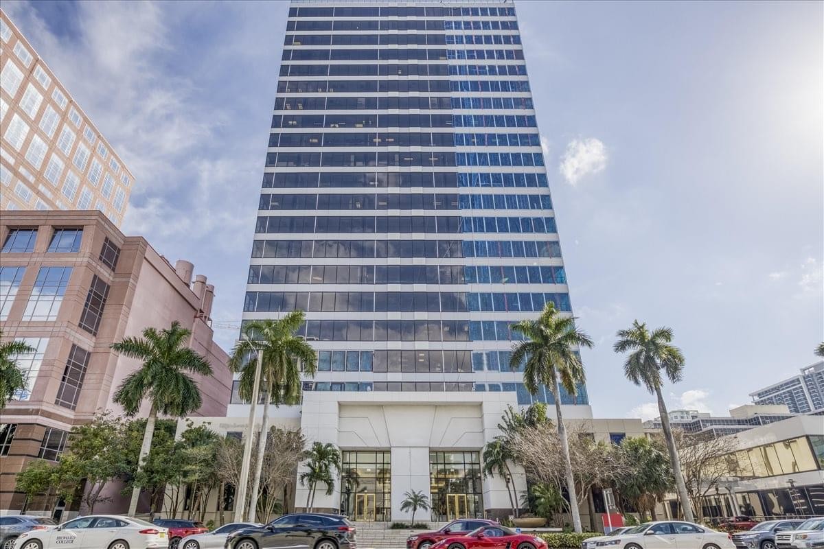 Exterior view of the glass-facade skyscraper at 110 East Broward Boulevard.