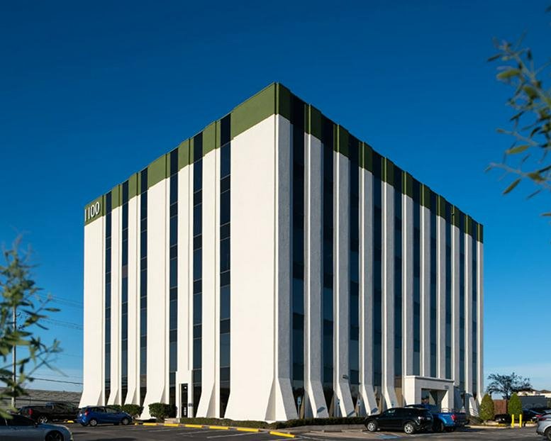 Exterior view of the white multi-story professional building at 1100 NASA Parkway.