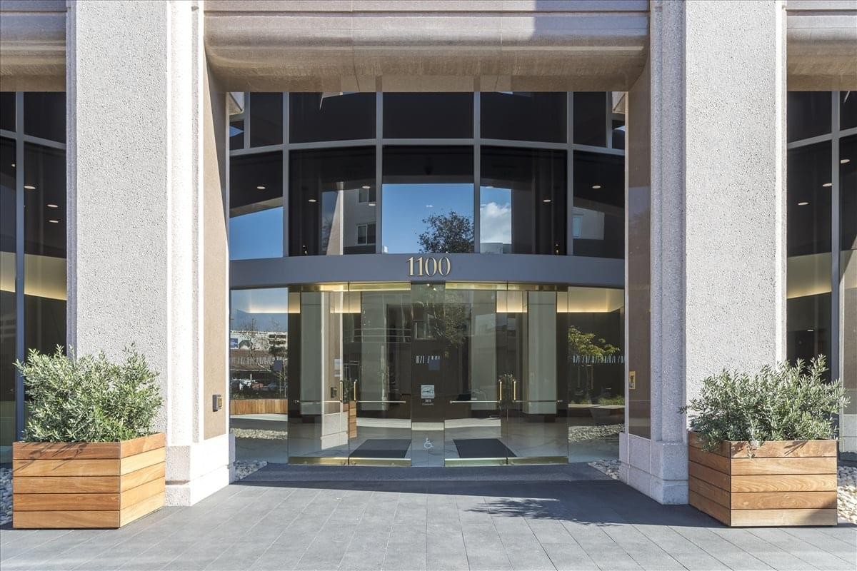 Exterior view of the glass-facade entrance at Orange Executive Tower.