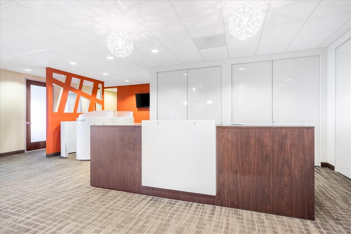 Reception area at 111 S. W. Fifth Avenue, Suite 3150 with a wood and white desk.