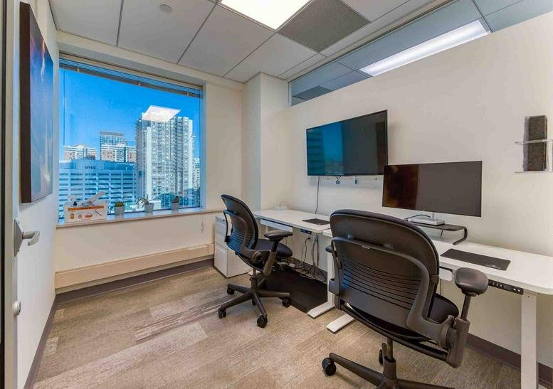Private office at 111 Town Square Pl, Newport with dual monitors and city views.