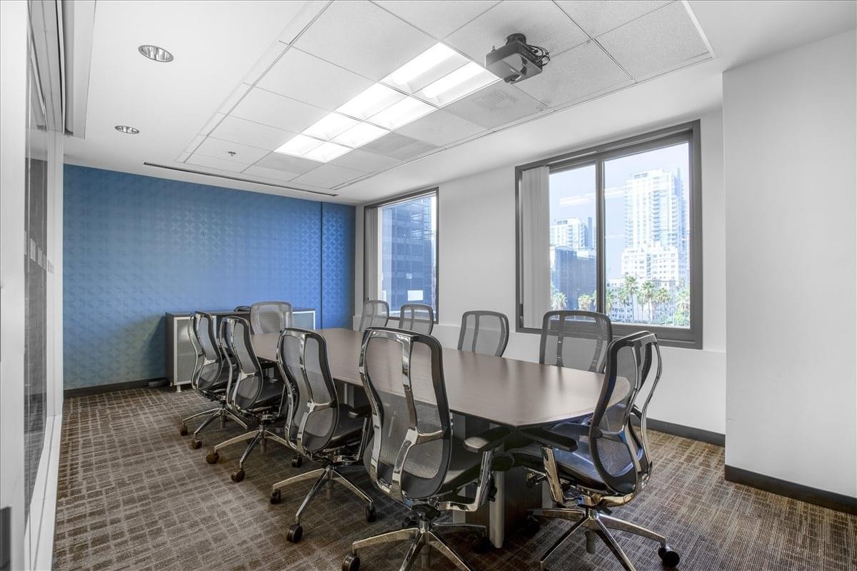 Spacious boardroom at 111 West Ocean Blvd, 4th Floor with a long table and blue acoustic wall.
