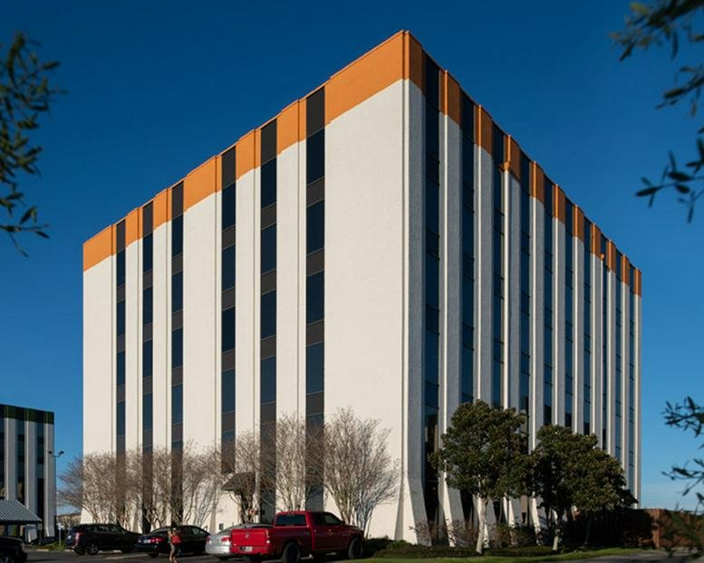 Exterior view of the white and orange facade at 1110 NASA Parkway.