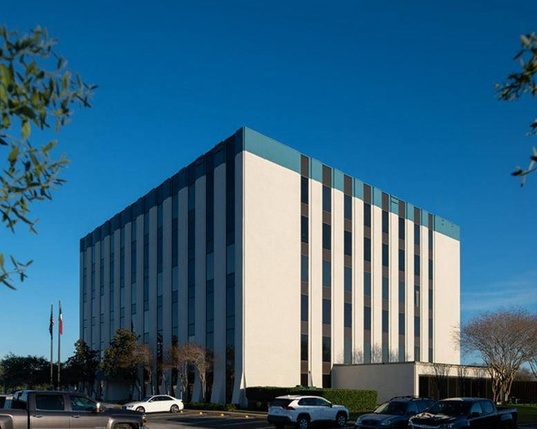 Exterior view of the white and blue multi-story office building at 1120 NASA Parkway.