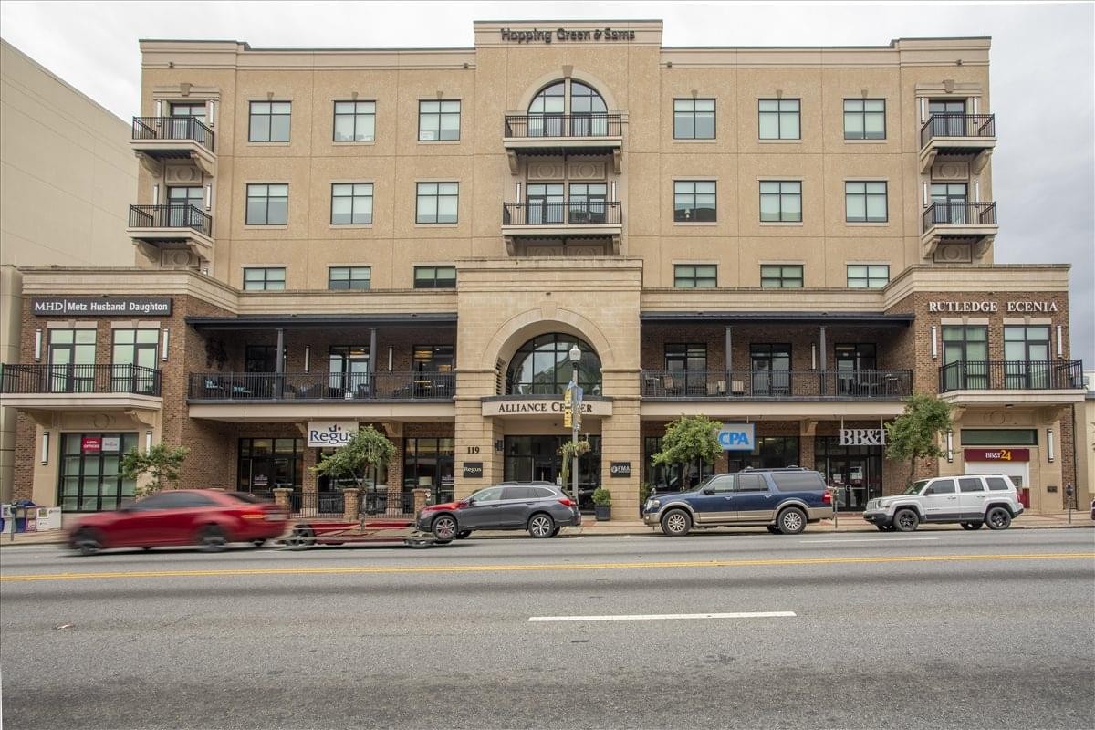 Exterior facade of the stone and brick building at 113 South Monroe Street.