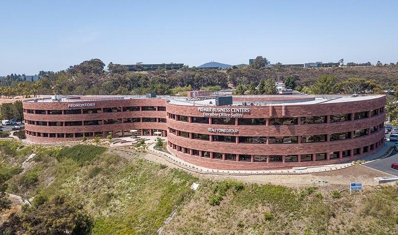 Exterior view of the red brick curved building at The Promontory in San Diego.
