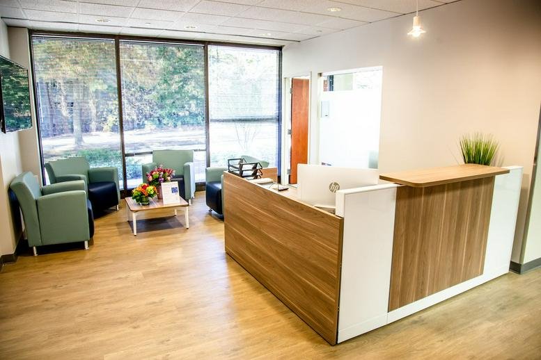 Bright reception area at 11720 Amber Park Dr, Ste. 160, Alpharetta (Georgia) with warm wood accents.