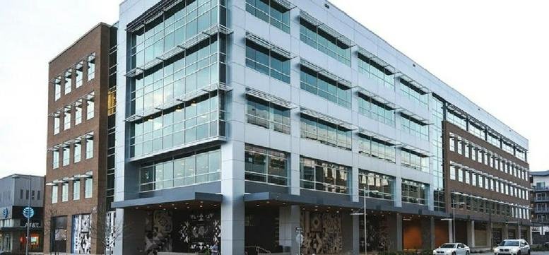 Exterior view of the modern glass and brick facade at 11801 Domain Blvd.